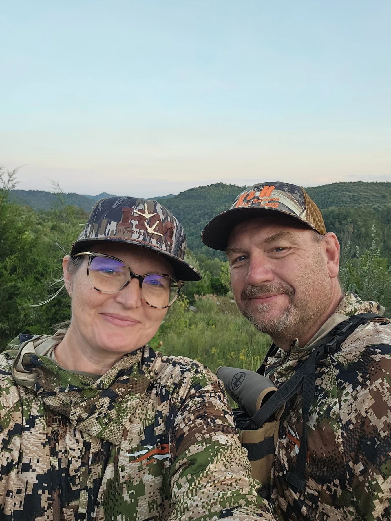 A Buck Creek family photo outdoors in camouflage